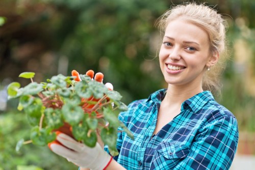 Team member trimming a hedge in Swiss Cottage, symbolising ethical labour practices